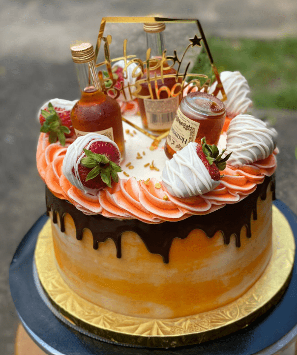 Creamsicle Hennessy Cake with chocolate drip 