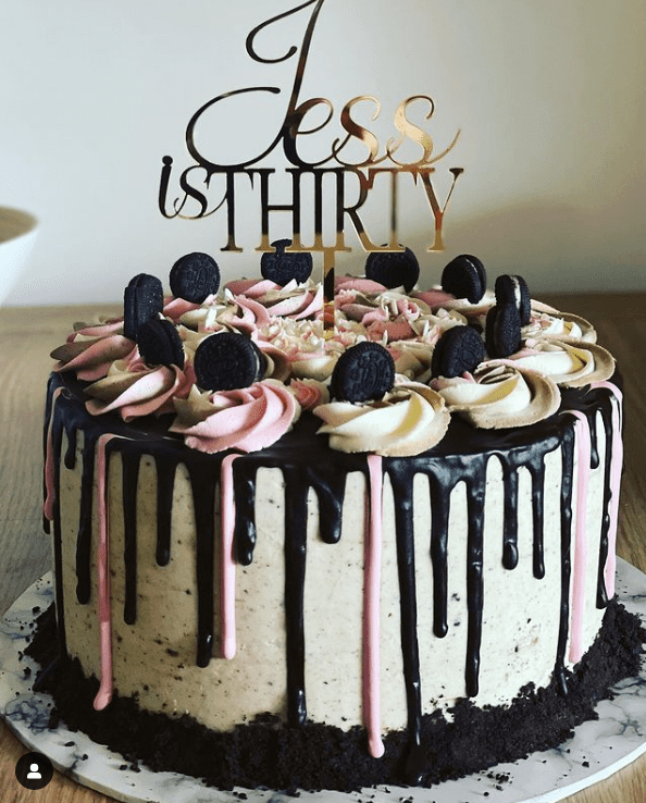 Pink, white, and black Oreo drip cake